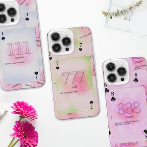 May include: Three iPhone cases with different designs. The first case features a pink and blue watercolor background with the number 111 and the text "Intuition, listen to your intuition". The second case features a pink and green watercolor background with the number 777 and the text "Luck, luck is on your side". The third case features a pink watercolor background with the number 888 and the text "Balance, you are in perfect harmony with the universe".