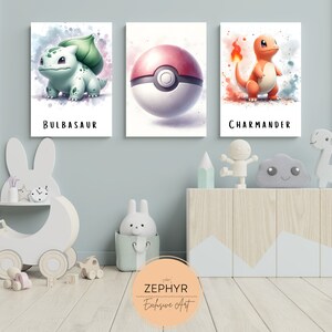 May include: Three watercolour-style prints featuring Pokemon characters. The prints are framed and hung on a light blue wall. The characters are Bulbasaur, a Pokeball, and Charmander.