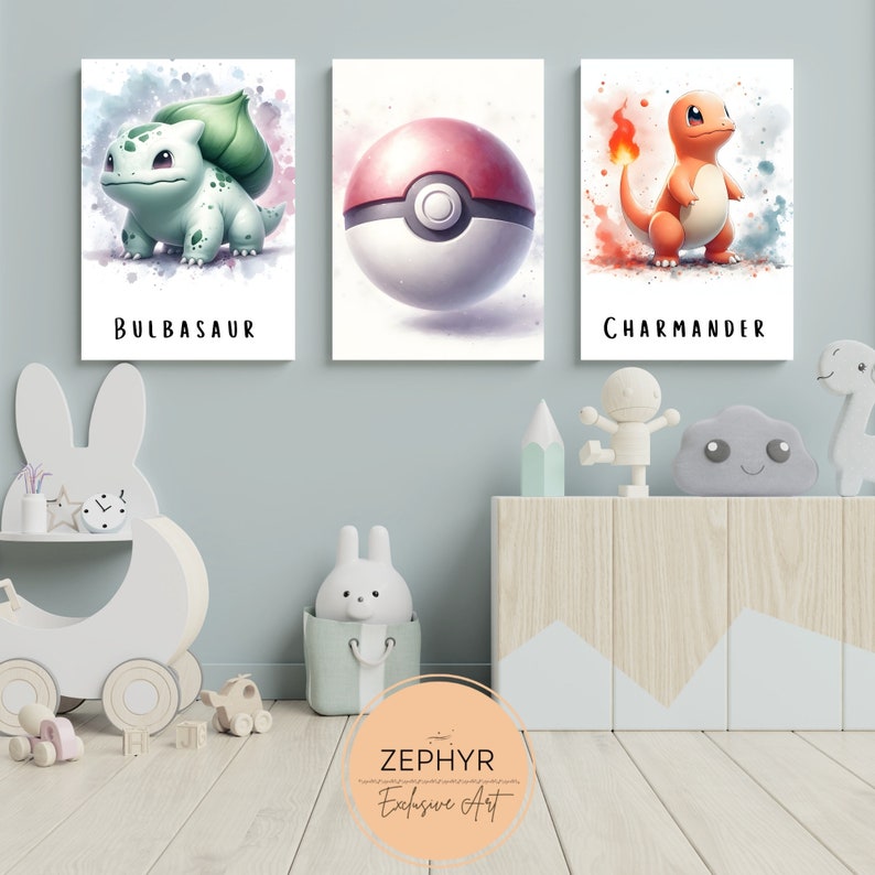 May include: Three watercolour-style prints featuring Pokemon characters. The prints are framed and hung on a light blue wall. The characters are Bulbasaur, a Pokeball, and Charmander.
