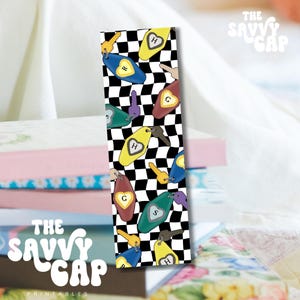 May include: A bookmark with a black and white checkered pattern. The bookmark features colorful keychains with letters on them. The keychains are yellow, blue, green, and maroon. The text "THE SAVVY GAP PRINTABLES" is at the top and bottom.
