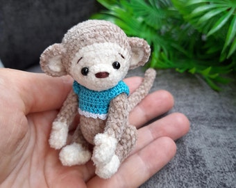 Pocket plush stuffed funny monkey toy in T-shirt. Cute tiny monkey. Mini teddy monkey. Animal for doll. Christmas, New Year, Birthday gift.