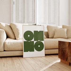 May include: A framed print with a geometric design featuring four green shapes, two circles and two squares, on a white background.