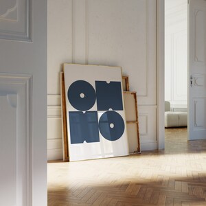 May include: A framed abstract art print with a white background and four blue geometric shapes. The shapes are arranged in a grid pattern and have a circular design.