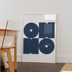 May include: A framed print with a geometric design featuring four navy blue shapes, including circles and squares, on a white background.
