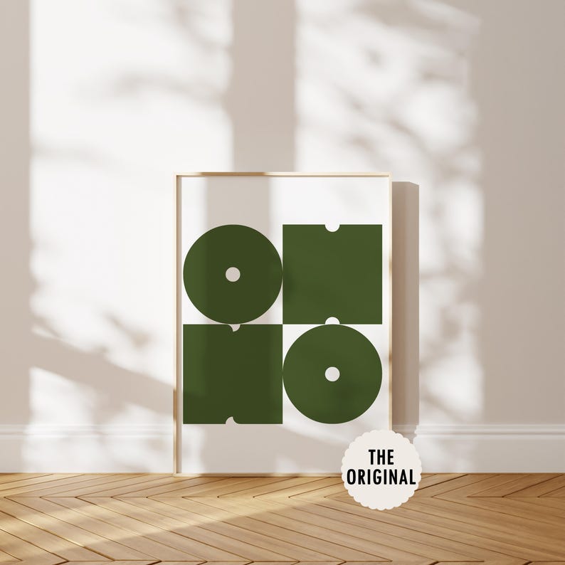 May include: A framed print with a geometric design featuring four shapes in a dark green color. The shapes are a circle, a square, and two rectangles. The print is on a white background and has the text "THE ORIGINAL" at the bottom.