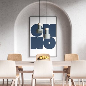 May include: A dining room with a wooden table and six chairs. The table is set with a bowl of lemons. A framed print with a blue geometric design hangs on the wall above the table. Two tall vases with dried pampas grass are on either side of the table.