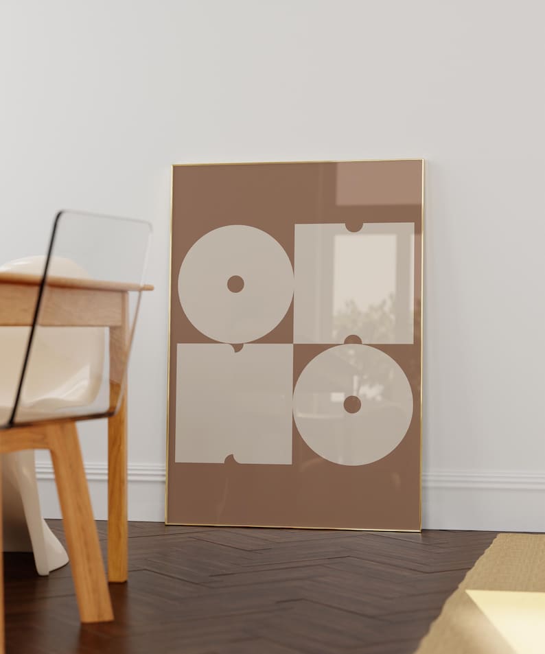 May include: A framed print with a geometric design featuring four white shapes on a brown background. The shapes are arranged in a grid pattern and resemble the letters "OHO".