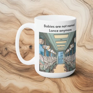 Puede incluir: Taza de cerámica blanca con una ilustración en blanco y negro de una guardería con bebés en incubadoras. El texto "Babies are not named Lance anymore" está impreso en la taza.