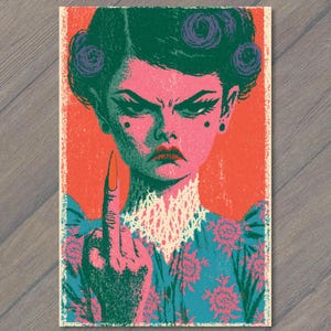 May include: A graphic print featuring a stylized person with dark green hair in buns, a stern expression, and a raised middle finger. The figure wears a blue floral garment with a white lace collar against a vibrant orange background.