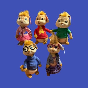 May include: Five plush Alvin and the Chipmunks characters. Each plush has a unique outfit, including a red hoodie with a yellow "A", a green hoodie, a blue sweater, a pink jacket and skirt, and a denim jacket and plaid skirt. The background is a solid blue.
