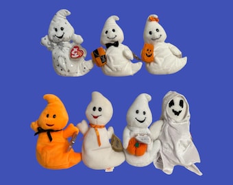 May include: A collection of ten plush ghost toys in various colors, including white, orange, and black. The ghosts have different facial expressions and are wearing various accessories, such as a black bow tie, a pumpkin, and a candy corn.