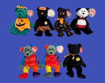 May include: A collection of ten Halloween-themed beanie babies. The beanie babies are all different colors and have different designs. Some of the beanie babies are wearing costumes, such as a pumpkin costume, a vampire costume, and a Frankenstein costume.