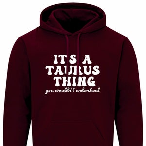 Puede incluir: Sudadera con capucha color burdeos con texto blanco que dice "It's a Taurus thing you wouldn't understand."