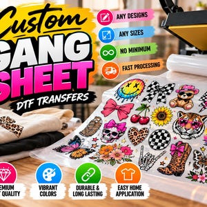 May include: A custom gang sheet of DTF transfers featuring various colorful graphic designs including a smiley face, teddy bear, tiger, skull, butterflies, flowers, and cowboy boots, displayed on a clear film sheet next to stacked t-shirts.