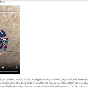 a hand holding a toy in front of a tiled wall