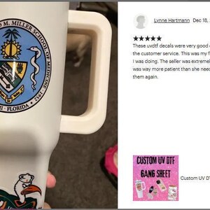 A person is holding a white mug with a blue and green emblem on it, and there is a review of the mug on a website.