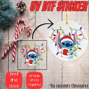 The image is a promotional advertisement for a UV DTF sticker that can be used to customize or decorate ornaments. It features a cartoon character, likely a character from the Disney movie Lilo and Stitch, surrounded by Christmas lights and candy canes. The sticker is designed to be used as a sticker or decal on ornaments, allowing users to personalize their ornaments with the character's image.