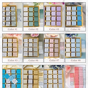 May include: A selection of personalized chocolates in various colors, arranged in gold trays. Each chocolate square features custom text and designs, with options for different paper colors. The image includes text that says "Please Choose the Paper Color."