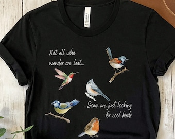 May include: Black t-shirt with a white graphic of five birds and the text "Not all who wander are lost... Some are just looking for cool birds."