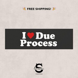 May include: A black rectangular graphic with the text "I ♥ Due Process" in white, with a red heart replacing the word "love". The graphic also includes the text "Sincity Apparel Co." and "Original Design".