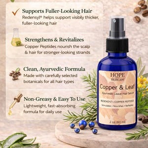 May include: A blue glass bottle of Hope Skincare Copper & Leaf Ayurvedic Leave-Hair Serum. The bottle has a black spray nozzle and a white label with product information. The image includes text about the product's benefits and ingredients, with a 2 oz (60 ml) size.