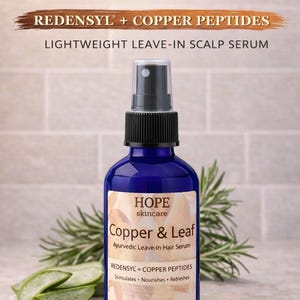 May include: A blue bottle of HOPE skincare Copper & Leaf Ayurvedic Leave-In Hair Serum. The label includes text: "Fuller-Looking Hair Support", "Redensyl + Copper Peptides", and "Lightweight Leave-In Scalp Serum". The bottle contains 2 oz / 60 ml.