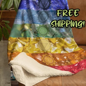 May include: A colorful fleece throw blanket with a rainbow design featuring seven chakra symbols and the text "FREE SHIPPING!"