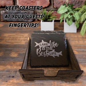 May include: A set of square slate coasters with the text "Lake Life is the Best Life" and fish illustrations. The coasters are in a wooden holder. The text "Keep coasters at your guests fingertips!" is at the top.