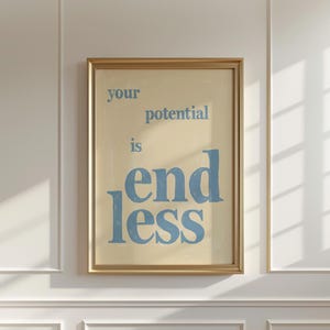 Könnte beinhalten: Gerahmter Kunstdruck mit den Worten "your potential is endless" in blauer Schrift auf cremefarbenem Hintergrund. Der Druck befindet sich in einem goldenen Rahmen und hängt an einer weißen Wand.