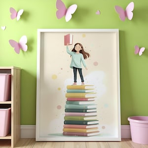 May include: A framed illustration depicts a young person standing atop a stack of colorful books, holding a book aloft. The illustration has a soft, pastel color palette. Pink butterflies decorate the green wall behind the framed art.
