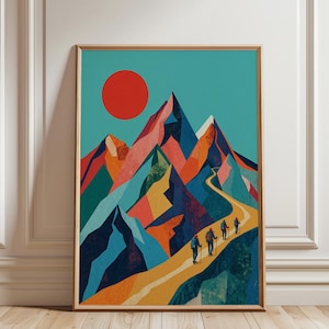 May include: Framed art print showing a vibrant mountain scene with a red sun and a path. Four figures hike along the path. The mountains are in blue, orange, and pink. The print is in a wooden frame.