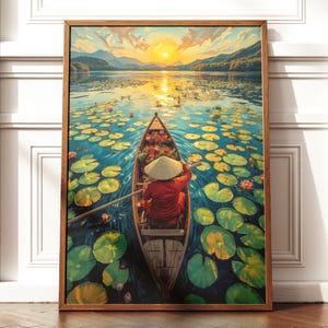 May include: A framed art print depicts a person in a boat on a lake at sunset. The person wears a red outfit and a conical hat, rowing through lily pads. The water reflects the golden sunlight and the surrounding mountains.