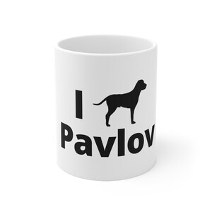 May include: White ceramic mug with a black silhouette of a dog and the text "I love Pavlov" printed on it.