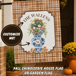 May include: A fall-themed house flag with a brown plaid background. The flag features a Chinoiserie vase filled with pumpkins and foliage, with the family name "The Wallens" above. The text "Customize Me!" is also visible.