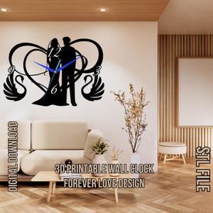 May include: 3D printable wall clock design featuring a couple standing in a heart shape with swans on either side. The clock face is black with white numbers and blue hands. The text "FOREVER LOVE DESIGN" is printed below the clock.