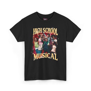 May include: Black t-shirt featuring a graphic of the High School Musical cast. The design includes the text "HIGH SCHOOL MUSICAL" in gold lettering, with a red and white background. The shirt is a classic crew neck style.