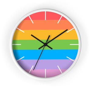 May include: A white round clock with black hands and a rainbow colored face. The clock face is divided into six horizontal stripes of red, orange, yellow, green, blue, and purple.