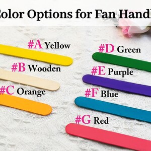 May include: Color options for a fan handle, shown as painted wooden sticks. The colors are yellow, wooden, orange, green, purple, blue, and red.
