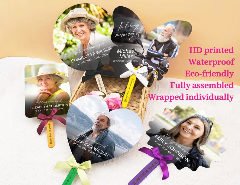 May include: A set of five memorial fans with black handles and colorful ribbons. Each fan features a photo of a person and their name, dates of birth and death, and the phrase "In loving memory of".
