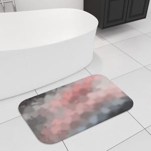 May include: A soft, rectangular bath mat with a pink and gray abstract cloud design. The mat is made of a soft, absorbent material and is perfect for adding a touch of style to your bathroom.
