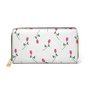 May include: A white ceramic mug with a black handle and the text "But First, Coffee" in a bold, black font. The mug is set against a blurred background, highlighting its simple design.