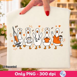 May include: A cream-colored t-shirt featuring a graphic print of five white ducks dressed as medical professionals. The ducks are depicted with orange accents, holding items including a syringe, a clipboard, a stethoscope, a pumpkin, and a coffee cup.