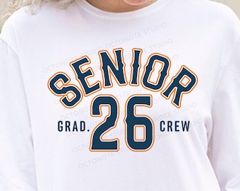 May include: A white t-shirt with a blue and orange graphic that says "Senior 26 Grad. Crew".