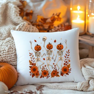 White square throw pillow featuring the Wildflower Skeleton artwork in a cozy boho fall setting.