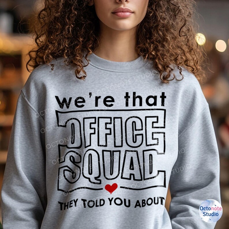 Curly-haired woman wears That Front Office Squad sweatshirt with bold heart detail – awesome for coworker appreciation or leadership quotes gift themes. Works well on hoodies, mugs, and planners.
