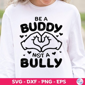 May include: White long-sleeve shirt with a black graphic design. The design features the words "BE A BUDDY NOT A BULLY" with a heart-shaped hand gesture and small hearts. The bottom of the image includes the text "SVG - DXF - PNG - EPS".