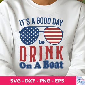 May include: White sweatshirt with a red, white and blue design. The design features a pair of sunglasses with an American flag pattern, the text "It's a good day to drink on a boat", and the words "drink" and "boat" in red.