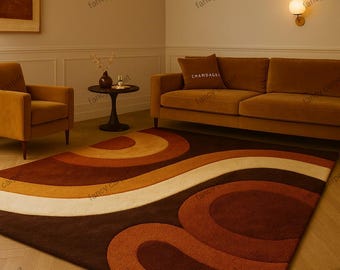 May include: A brown, orange, and cream-colored area rug with a retro wave design. The rug is placed in a living room with a brown sofa, armchair, and side table. The room has a warm, inviting atmosphere.
