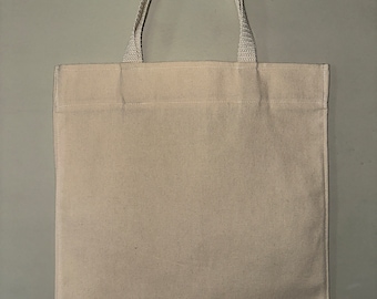 May include: A plain white canvas tote bag with two white fabric handles.