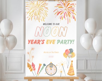 May include: A white sign on a wooden easel with the text "WELCOME TO OUR NOON YEAR'S EVE PARTY!" in colorful letters. The sign includes illustrations of fireworks, balloons, and a clock. The sign is surrounded by white and beige balloons.